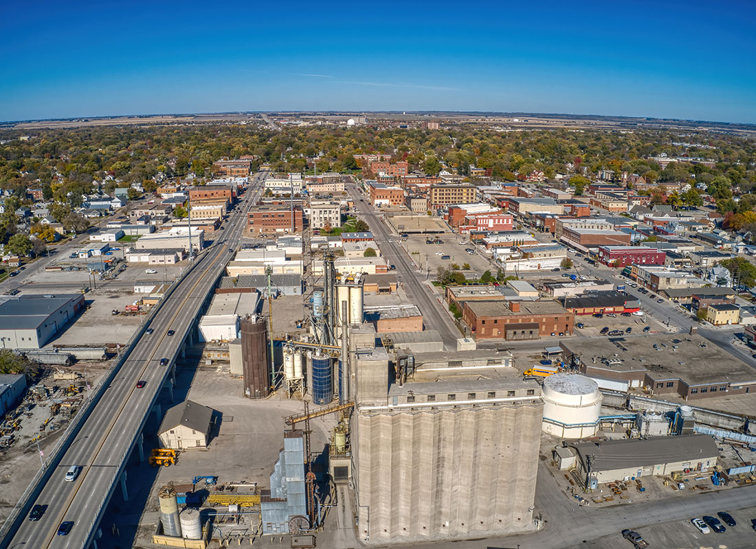 Fremont, NE - Aerial View of Buildings and Roads in the Suburb of Fremont Nebraska on a Sunny Day with a Bright Blue Sky